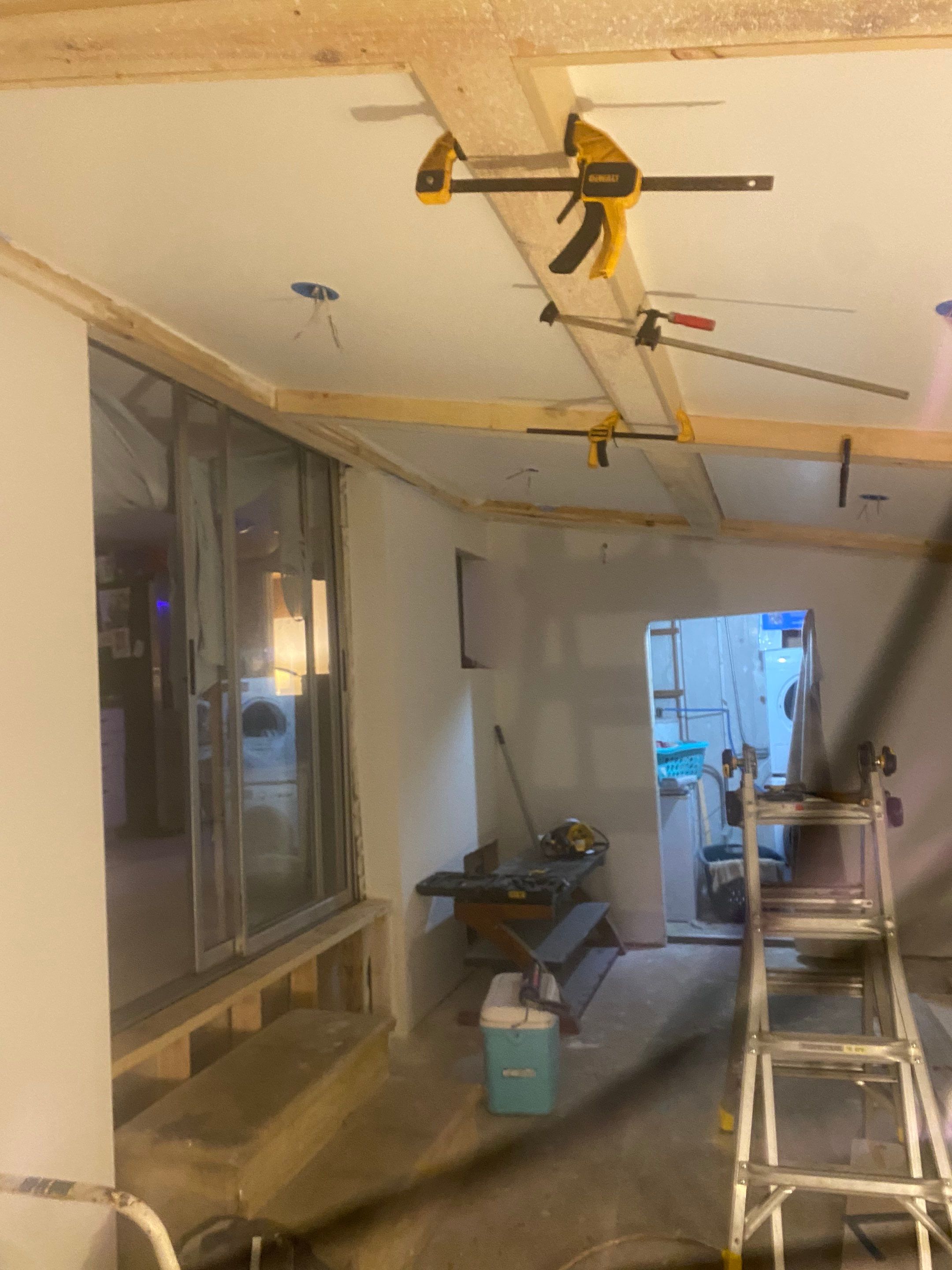 Middle stages of a remodel and drywall repair after storm damage
